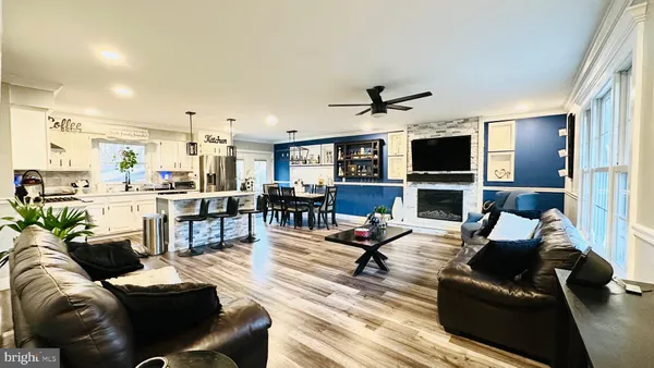 a kitchen with kitchen island granite countertop a sink stainless steel appliances and cabinets