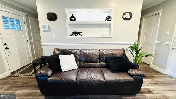 a view of a room with furniture and wooden floor