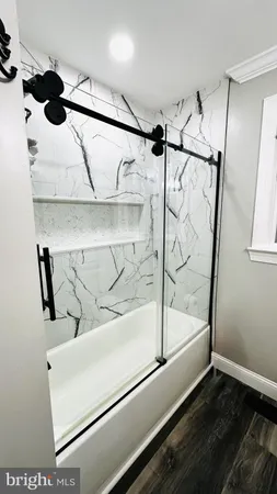 a bedroom with a bed and the view of a bathroom