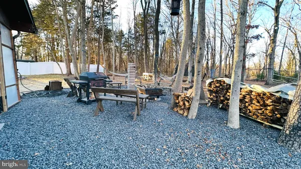 a view of a house with a backyard and sitting area