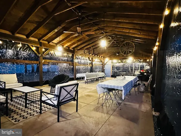 a view of a patio with table and chairs with wooden floor and fence