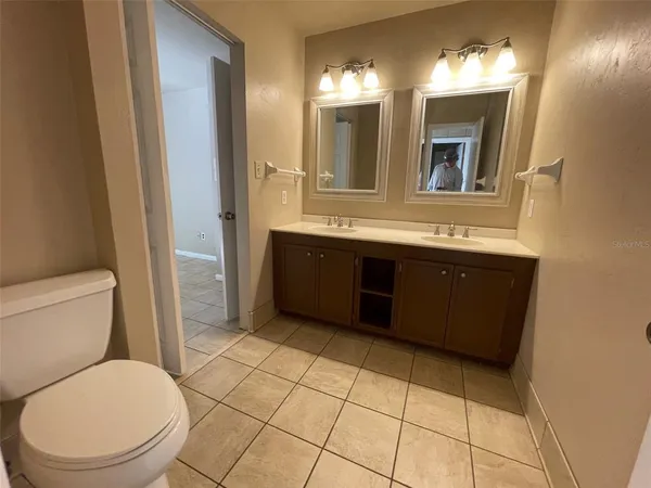 a bathroom with a sink vanity mirror and toilet