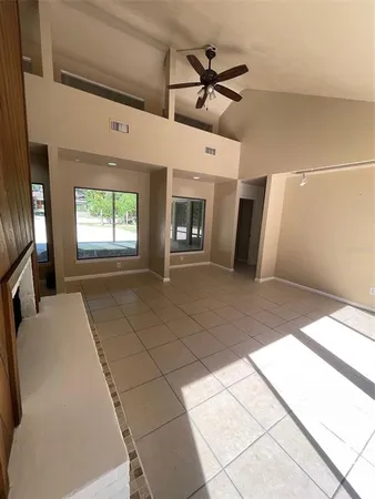 a view of a livingroom with a ceiling fan and window