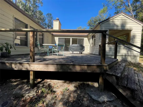 a house view with a sitting space fire pit and outdoor space