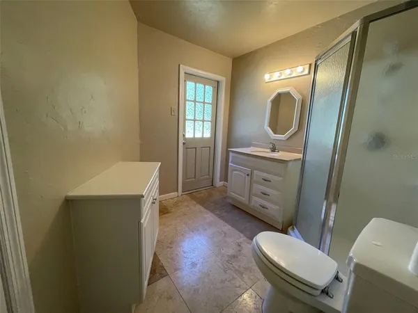 a bathroom with a sink a toilet and mirror