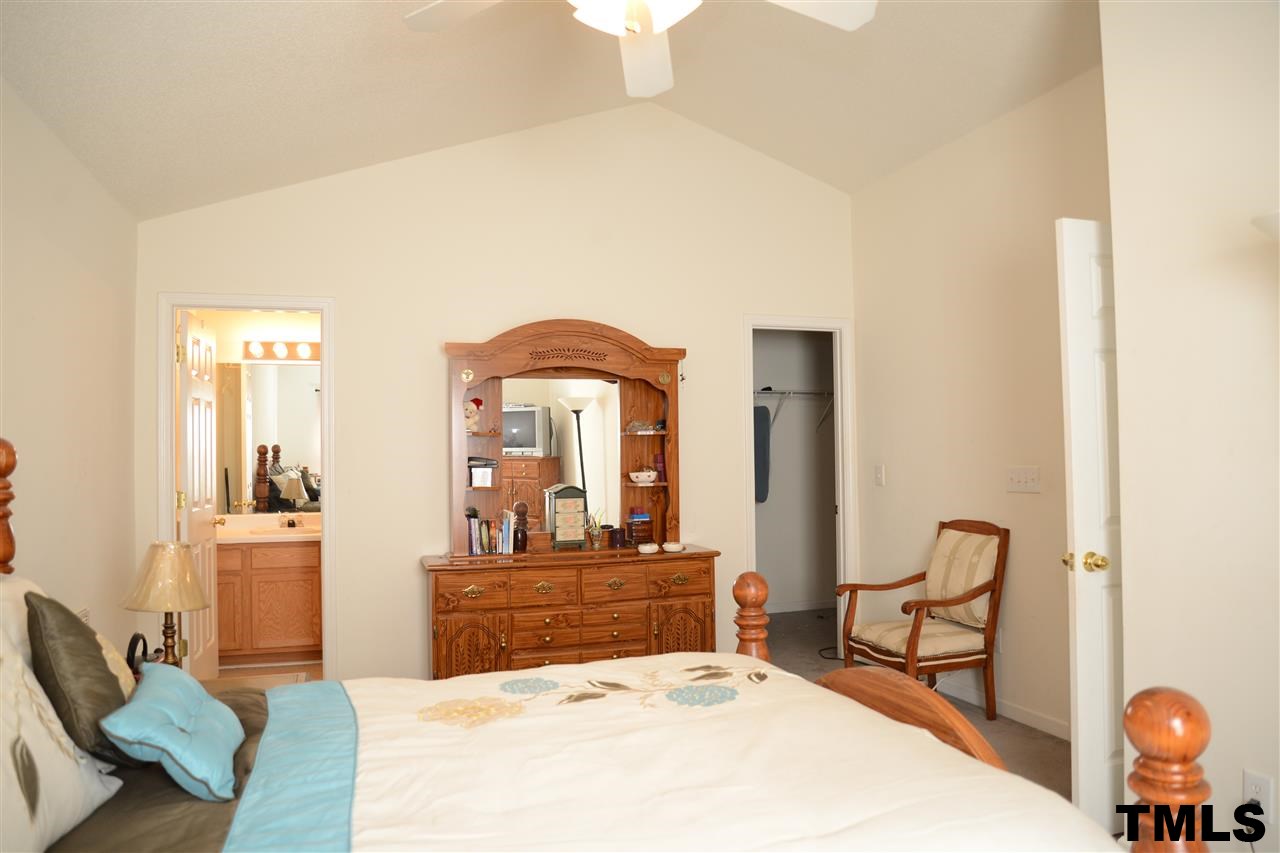 8116 Inverbrass Court Raleigh, NC 27616 - Photo 16 of 25 a bedroom with a bed and large windows
