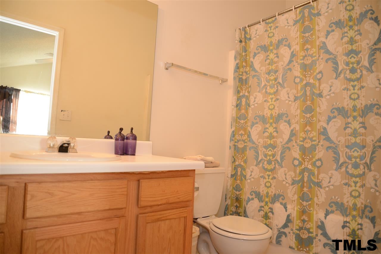 8116 Inverbrass Court Raleigh, NC 27616 - Photo 17 of 25 a bathroom with a sink a toilet and a mirror