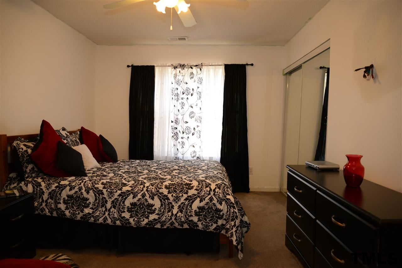 8116 Inverbrass Court Raleigh, NC 27616 - Photo 20 of 25 a bedroom with a bed and a window