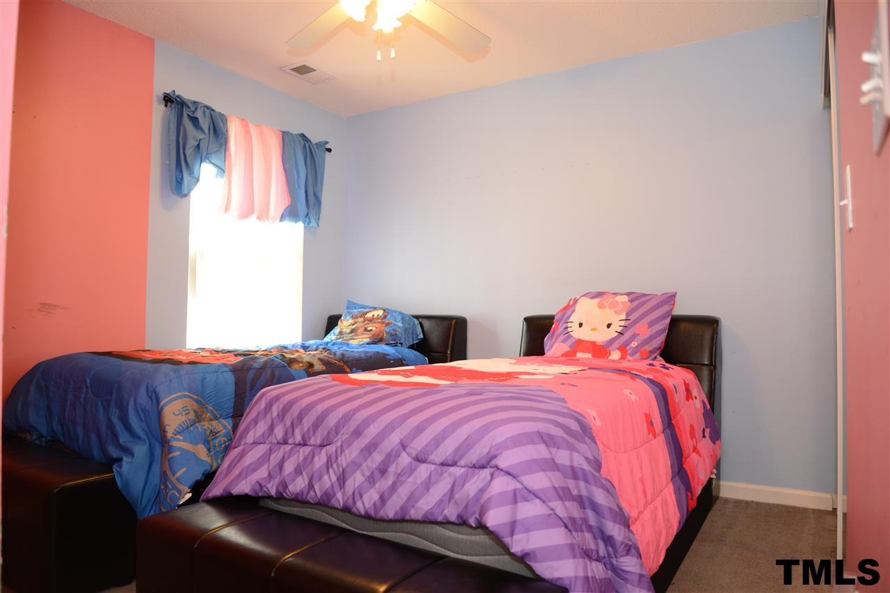 8116 Inverbrass Court Raleigh, NC 27616 - Photo 22 of 25 a bedroom with two beds and a large window