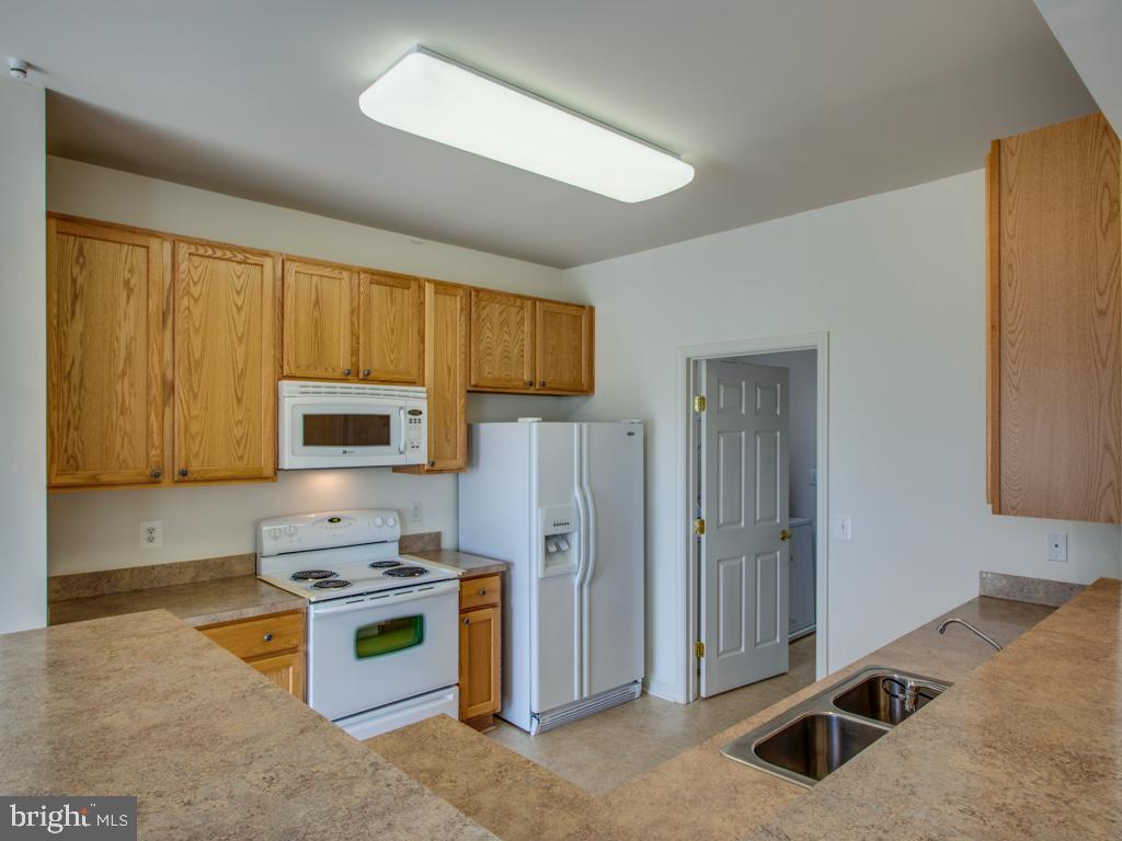 24833 Rivers Edge Road Millsboro, DE 19966 - Photo 11 of 26 KITCHEN TAKEN FROM BREAKFAST BAR