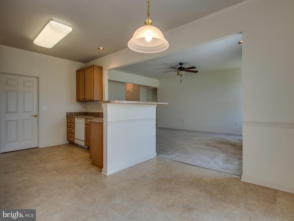 24833 Rivers Edge Road Millsboro, DE 19966 - Photo 12 of 26 DINING AREA W/KITCHEN AT LEFT; LIVING RM AT RIGHT