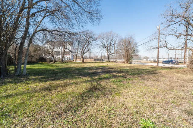 a big yard with road and trees
