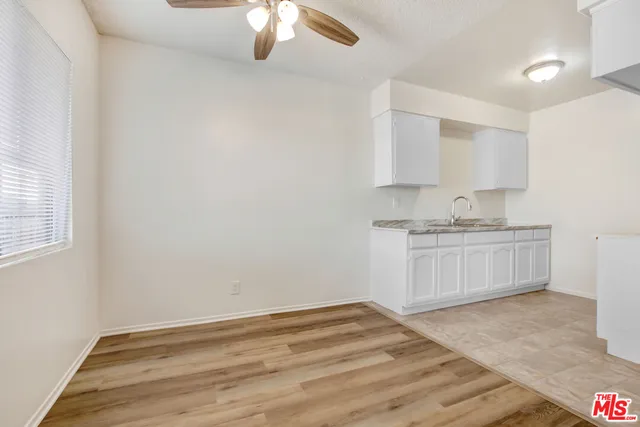 a view of kitchen with granite countertop cabinets and sink
