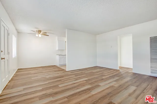 a view of an empty room and wooden floor