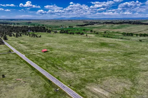 a view of a green field with an outdoor space