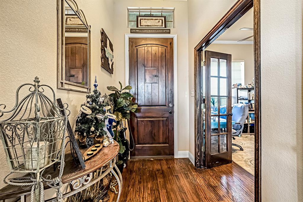 3206 Meadow Ridge Drive Midlothian, TX 76065 - Photo 14 of 37 a view of a hallway with wooden floor and windows