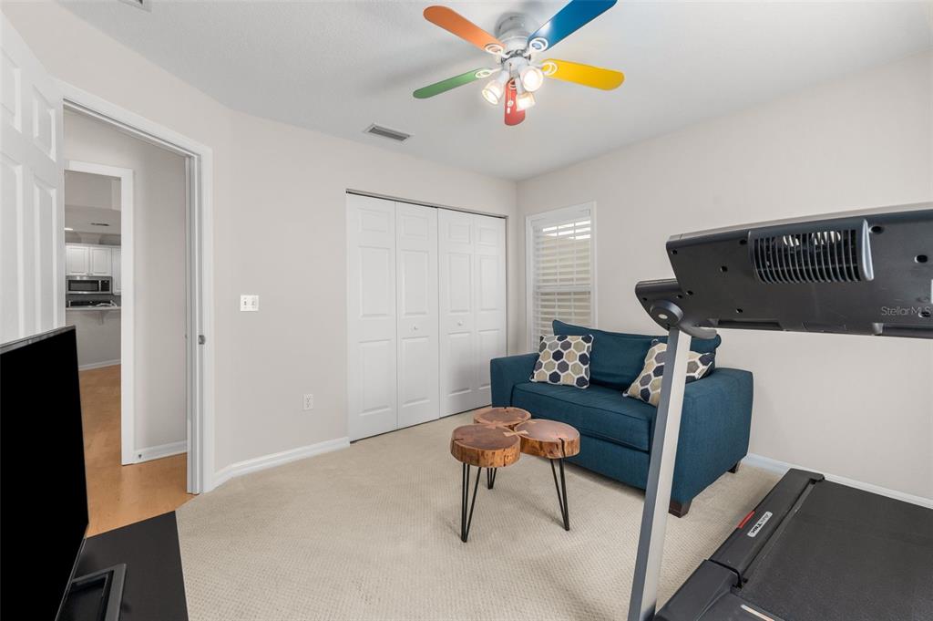 7418 White Oaks Road Alachua, FL 32615 - Photo 22 of 46 a living room with furniture and a chandelier