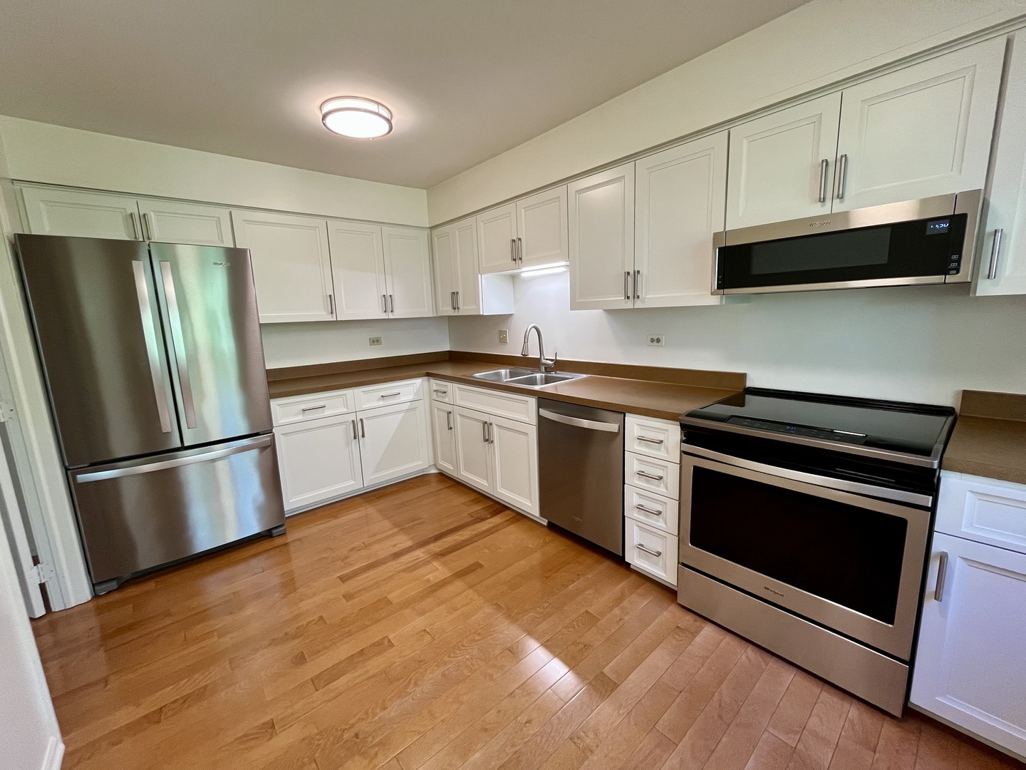 315 Bluff Court, Unit C Lake Barrington, IL 60010 - Photo 12 of 43 a kitchen with stainless steel appliances white cabinets and a refrigerator