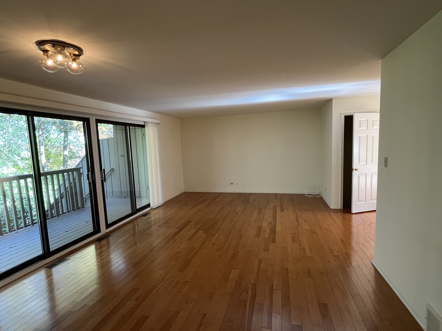 315 Bluff Court, Unit C Lake Barrington, IL 60010 - Photo 4 of 43 a view of empty room with wooden floor and fan