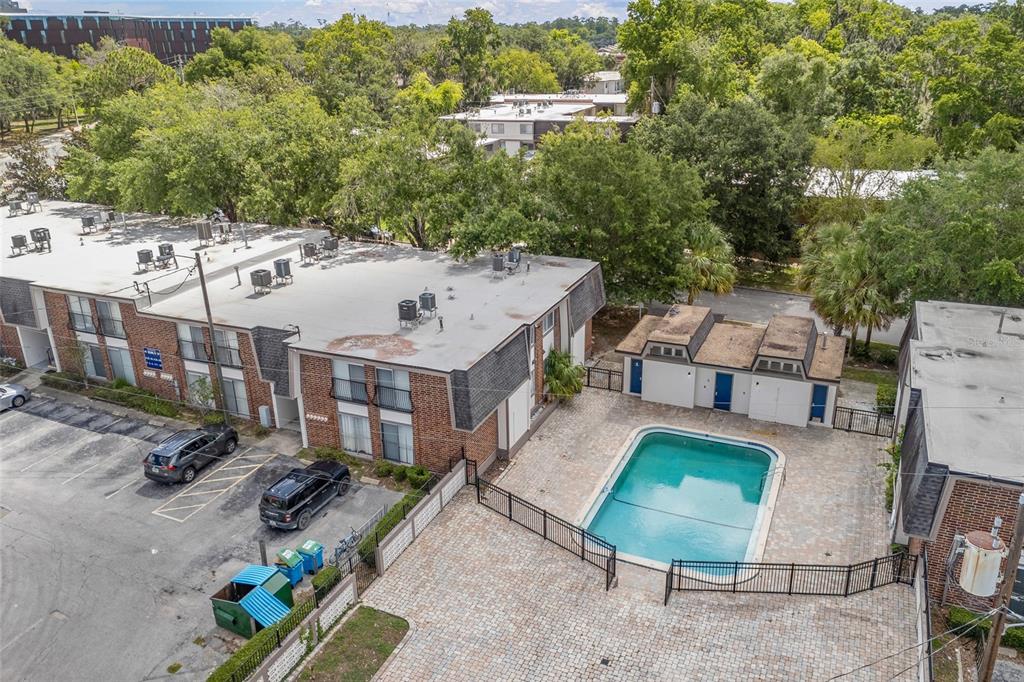 1700 Southwest 16th Court, Unit E29 Gainesville, FL 32608 - Photo 13 of 15 an aerial view of a house with swimming pool and furniture