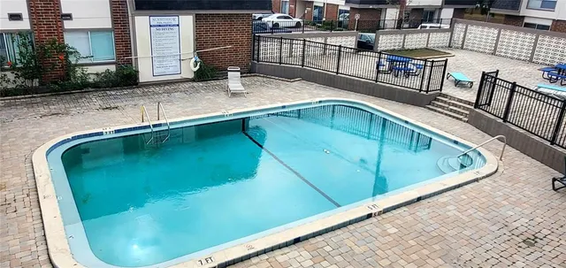 a swimming pool with outdoor seating and yard