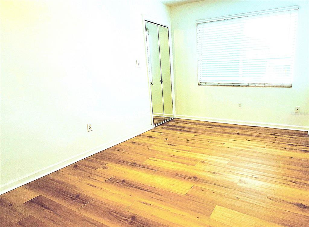 1700 Southwest 16th Court, Unit E29 Gainesville, FL 32608 - Photo 6 of 15 a view of a room with wooden floor and a window