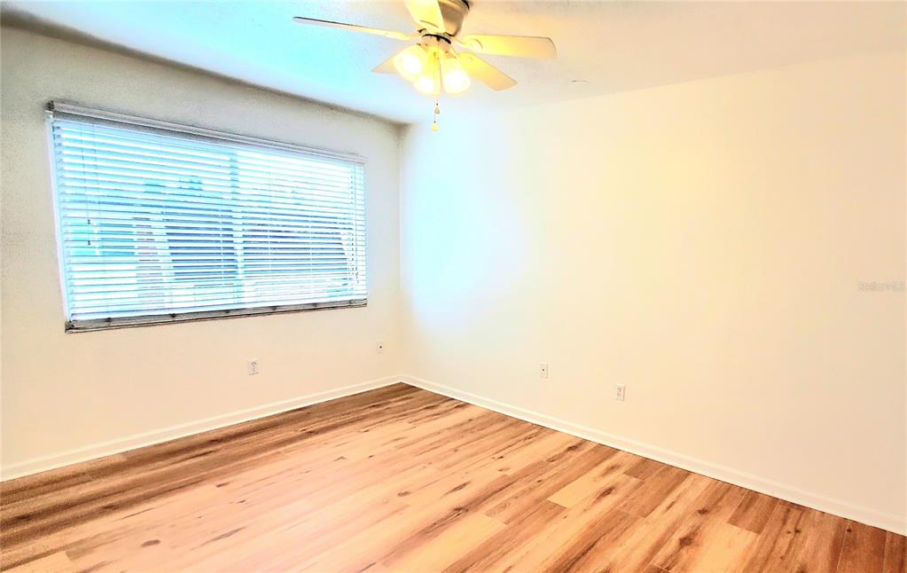 1700 Southwest 16th Court, Unit E29 Gainesville, FL 32608 - Photo 7 of 15 a view of a room with a window and a ceiling fan