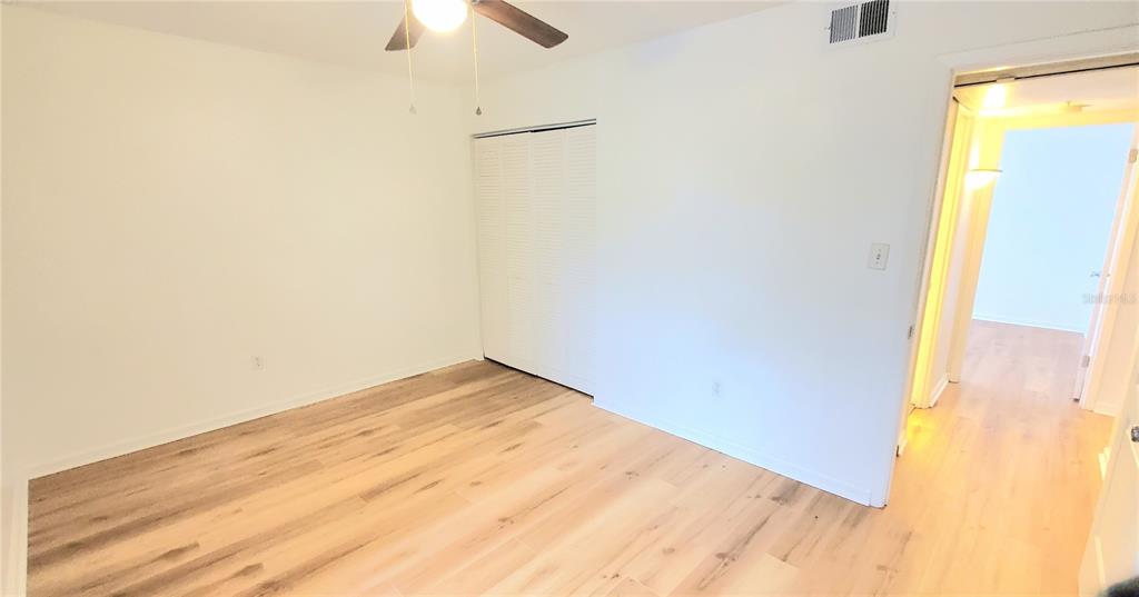 1700 Southwest 16th Court, Unit E29 Gainesville, FL 32608 - Photo 9 of 15 a view of empty room with wooden floor
