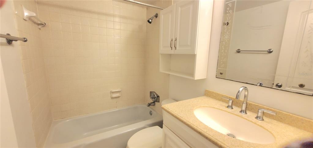 1700 Southwest 16th Court, Unit E29 Gainesville, FL 32608 - Photo 10 of 15 a bathroom with a granite countertop sink toilet and shower