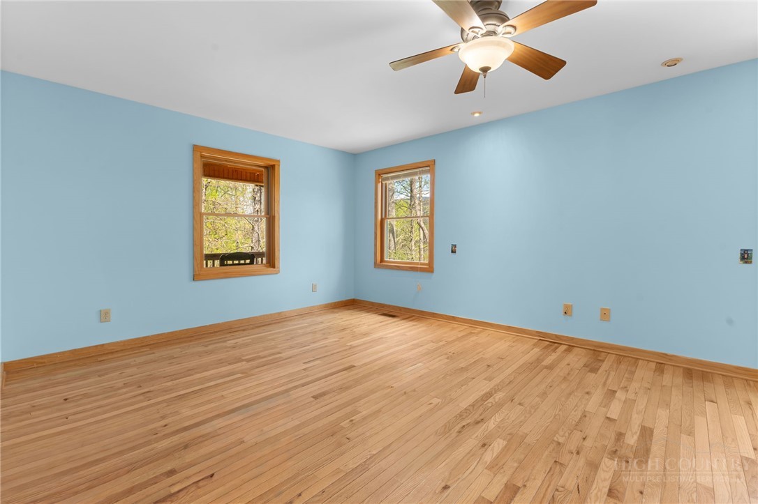 148 Woodby Ridge Road Vilas, NC 28692 - Photo 16 of 33 a view of an empty room with window and a chandelier fan