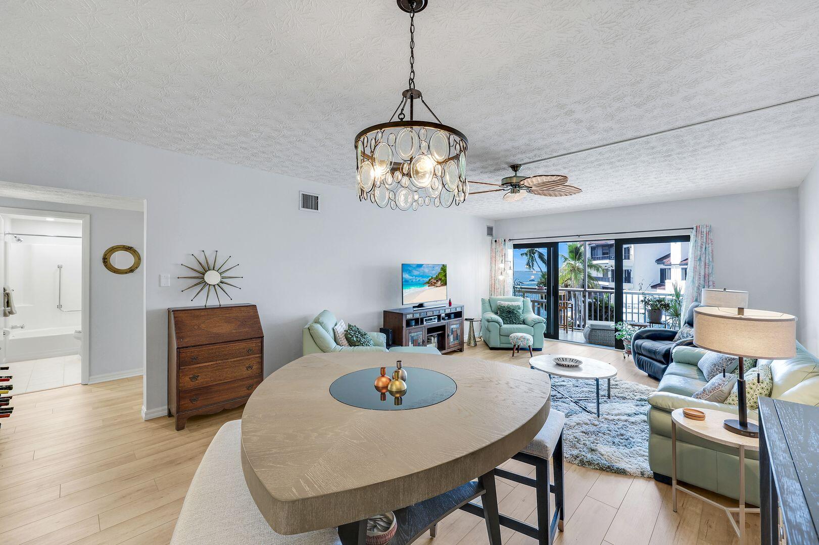 60 West Pelican Street, Unit 407 Naples, FL 34113 - Photo 12 of 26 a view of a dining room with furniture window and wooden floor