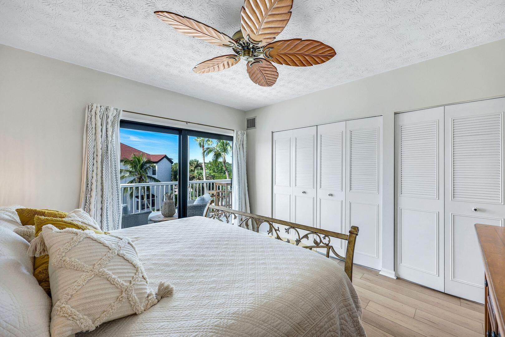 60 West Pelican Street, Unit 407 Naples, FL 34113 - Photo 14 of 26 a bedroom with a bed and a window