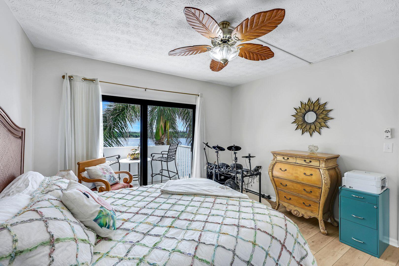 60 West Pelican Street, Unit 407 Naples, FL 34113 - Photo 16 of 26 a bedroom with a bed and wooden floor