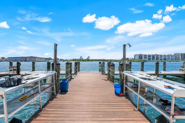 a view of a balcony with wooden floor and iron fence