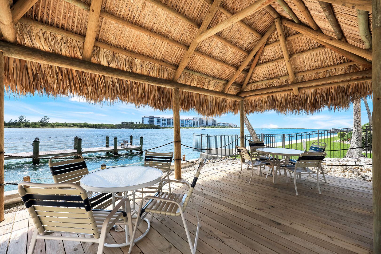 60 West Pelican Street, Unit 407 Naples, FL 34113 - Photo 24 of 26 a view of a chairs and table in the patio