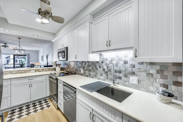 a kitchen with a sink stove and cabinets