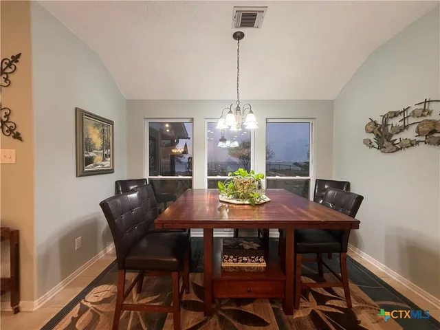 a view of a hallway with toilet and a bathroom