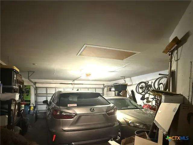 a hallway with wooden floor and a bathroom