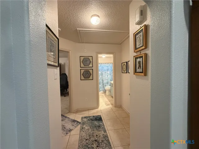 a bathroom with a granite countertop shower a sink and a mirror