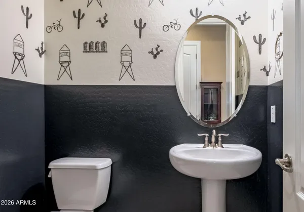 a bed with a white comforter and pillows