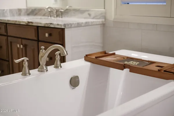 a view of a floor to ceiling window with tree in front of it