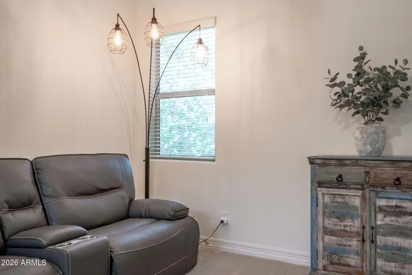 a view of a patio with table and chairs under an umbrella with a small yard