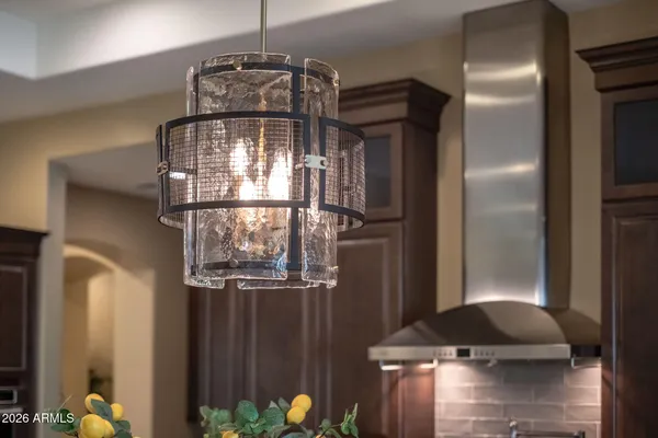 a kitchen with stainless steel appliances granite countertop a sink a stove and a refrigerator