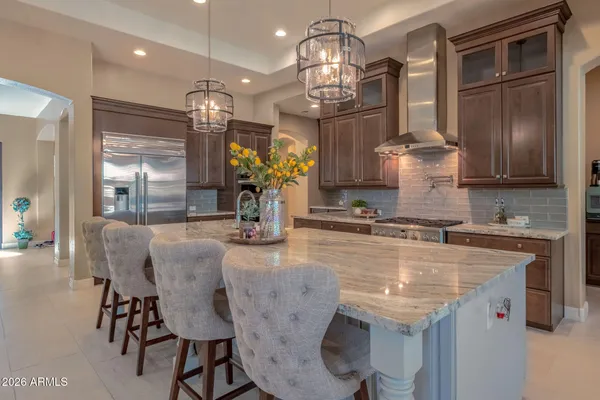 a kitchen with stainless steel appliances granite countertop a stove microwave and sink