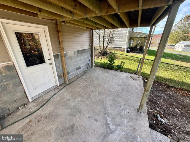 a view of a porch with a table and chairs