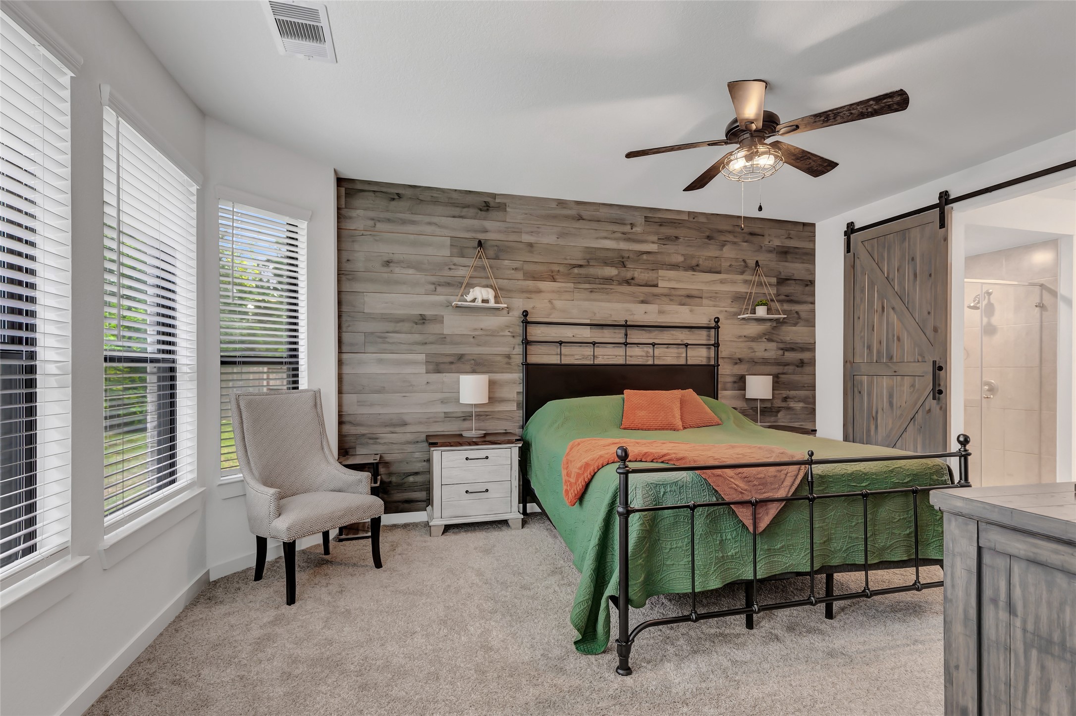 527 Chestnut Reef Court Conroe, TX 77304 - Photo 20 of 40 a bedroom with a bed and a chandelier
