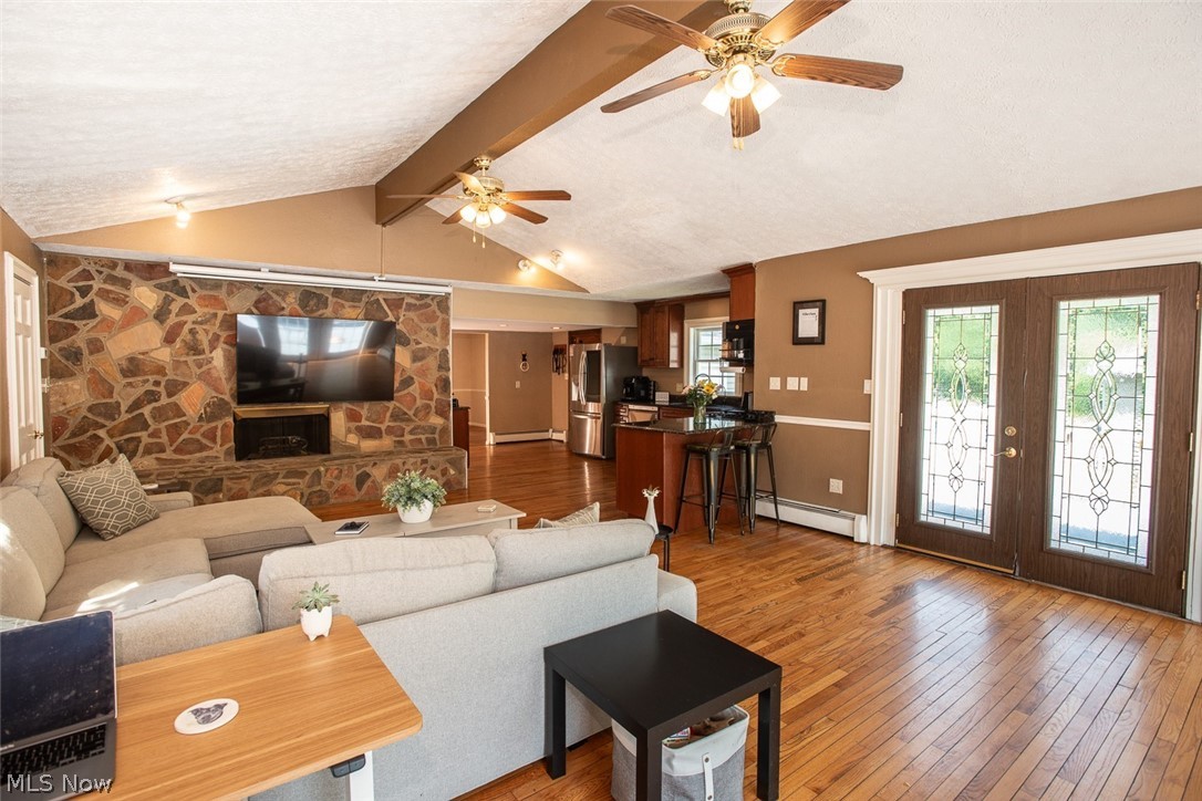 7075 Valley View Road Hudson, OH 44236 - Photo 7 of 17 Living room featuring french doors, vaulted ceiling with beams, and hardwood flooring