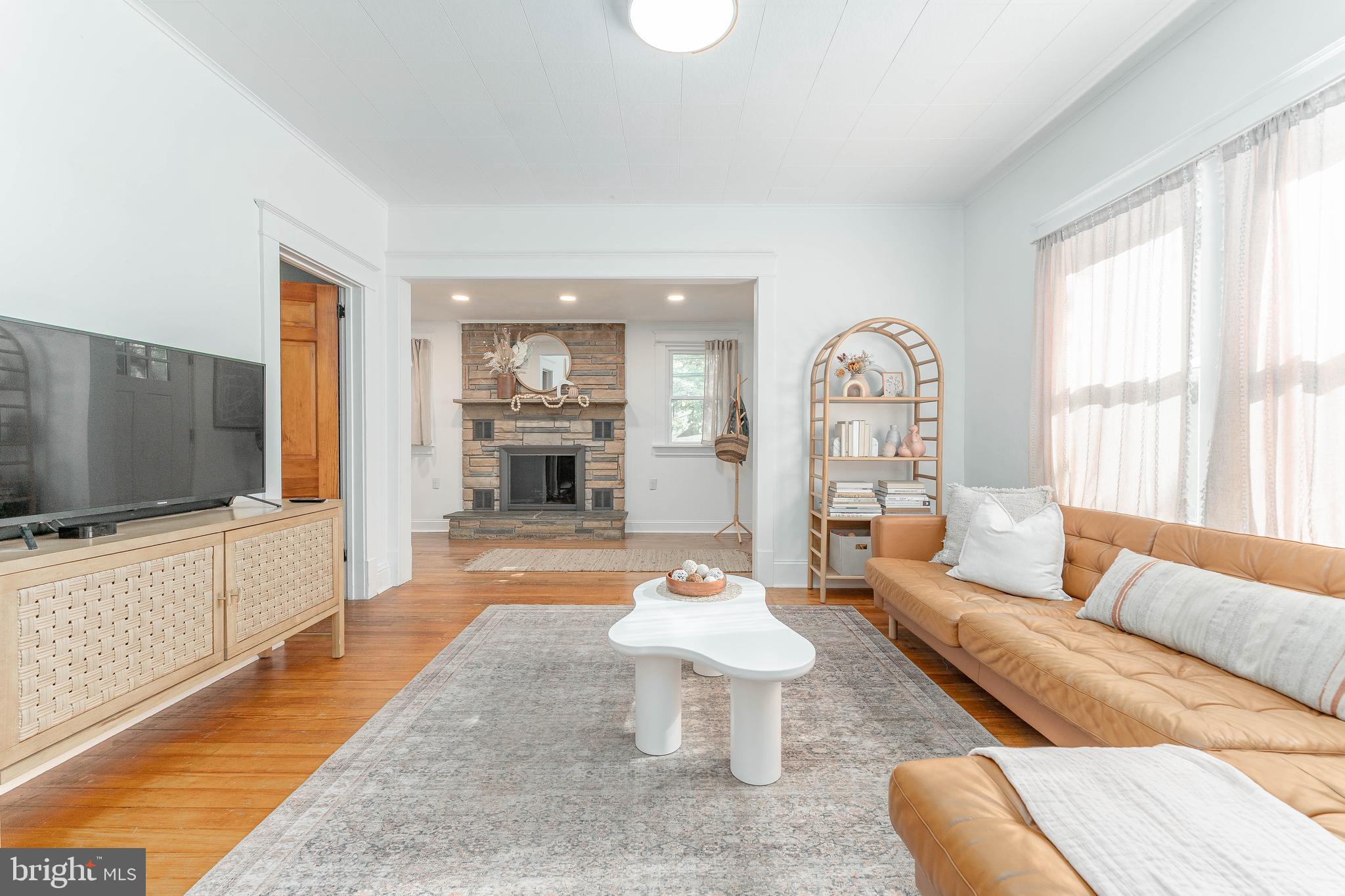 864 North Avenue Springfield, PA 19064 - Photo 12 of 33 a living room with furniture a flat screen tv and a large window