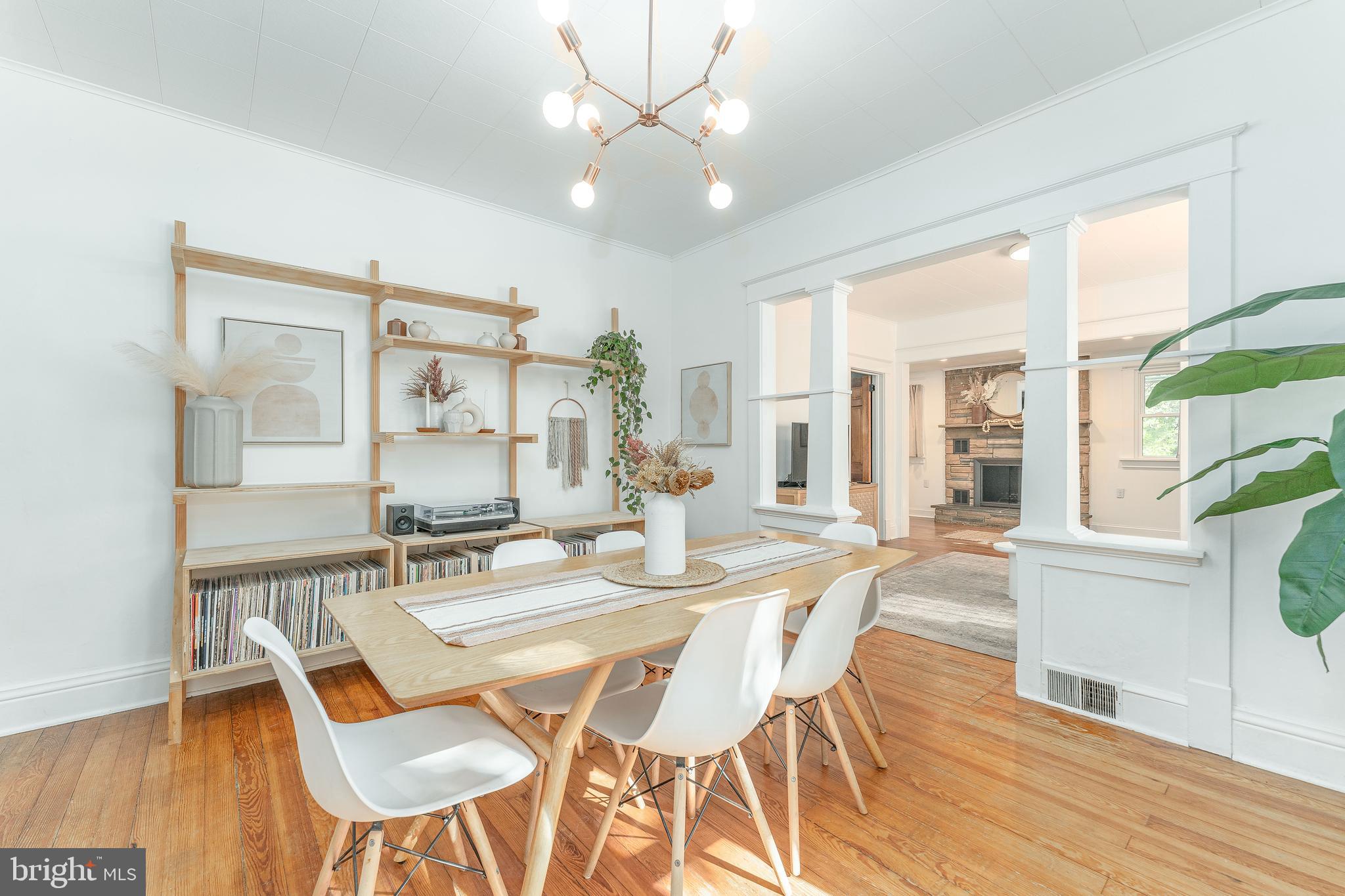 864 North Avenue Springfield, PA 19064 - Photo 17 of 33 a dining room with wooden floor a chandelier fan a wooden table and chairs