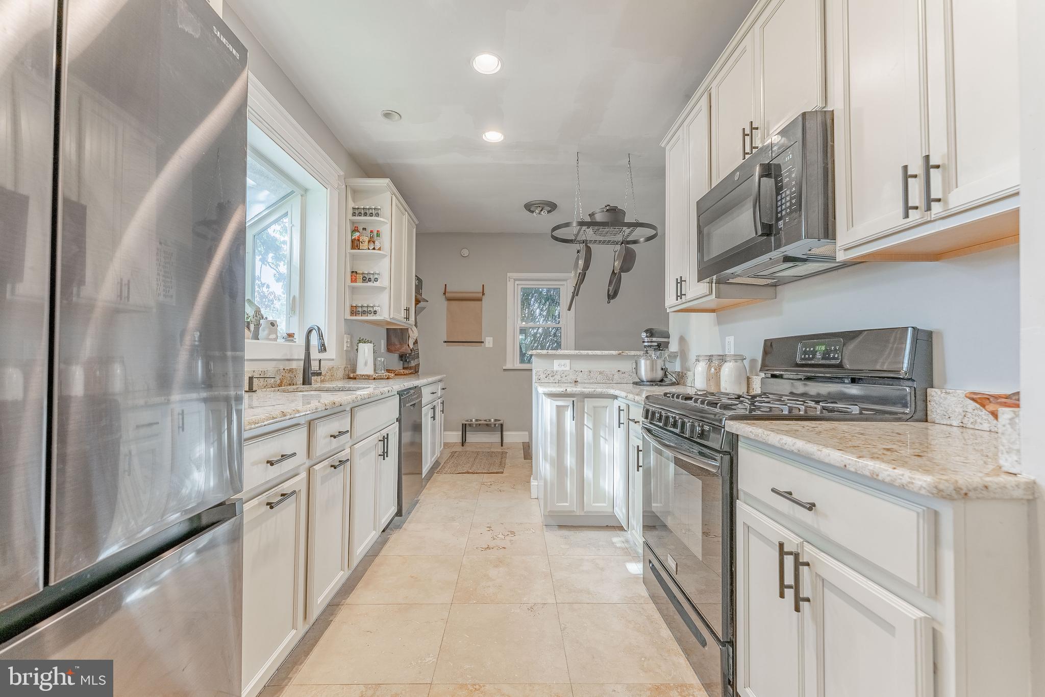 864 North Avenue Springfield, PA 19064 - Photo 19 of 33 a kitchen with stainless steel appliances granite countertop a sink and cabinets